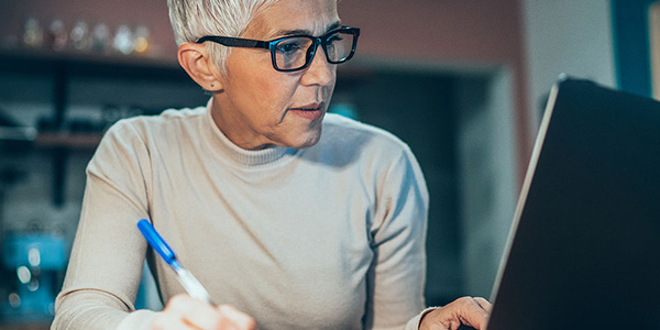 woman writing with pen in hand
