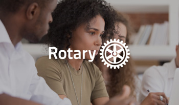 people in meeting with Rotary logo overlay