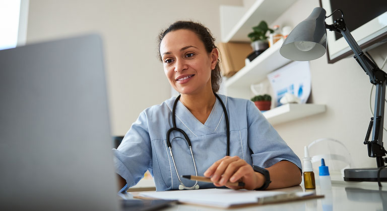 healthcare worker on laptop