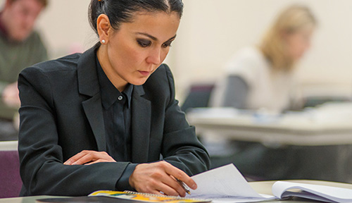 person in classroom at desk