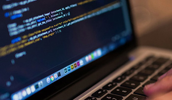 laptop with code displayed on screen