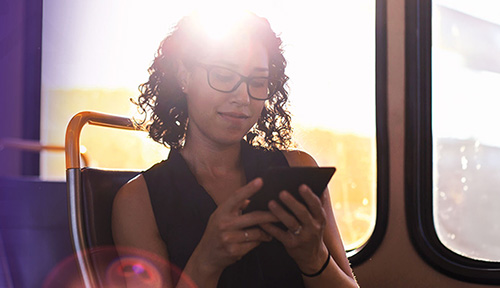 person looking at mobile device on bus