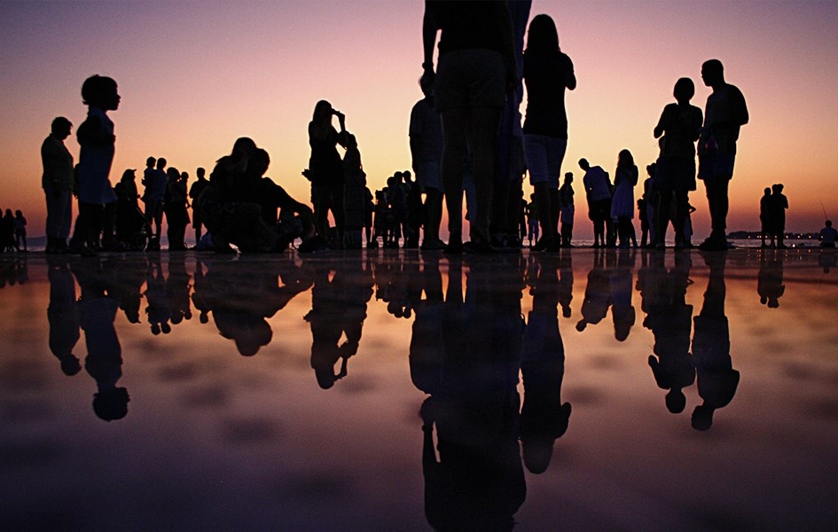 people gathered at sunset