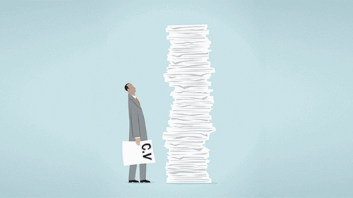 Person staring at a stack of paper.