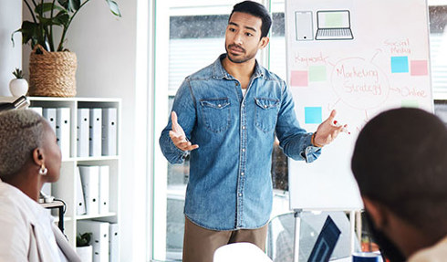 man giving presentation in front of white board